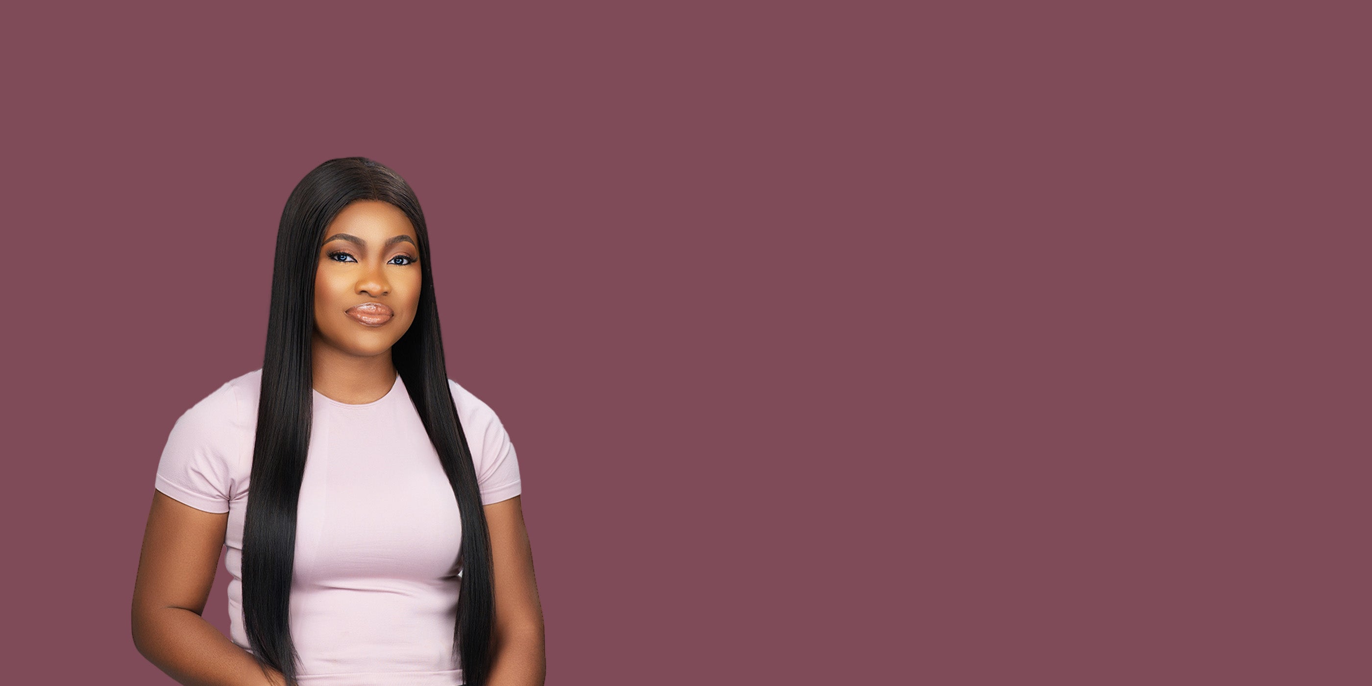 Woman with long black hair wearing a white t-shirt on a purple background